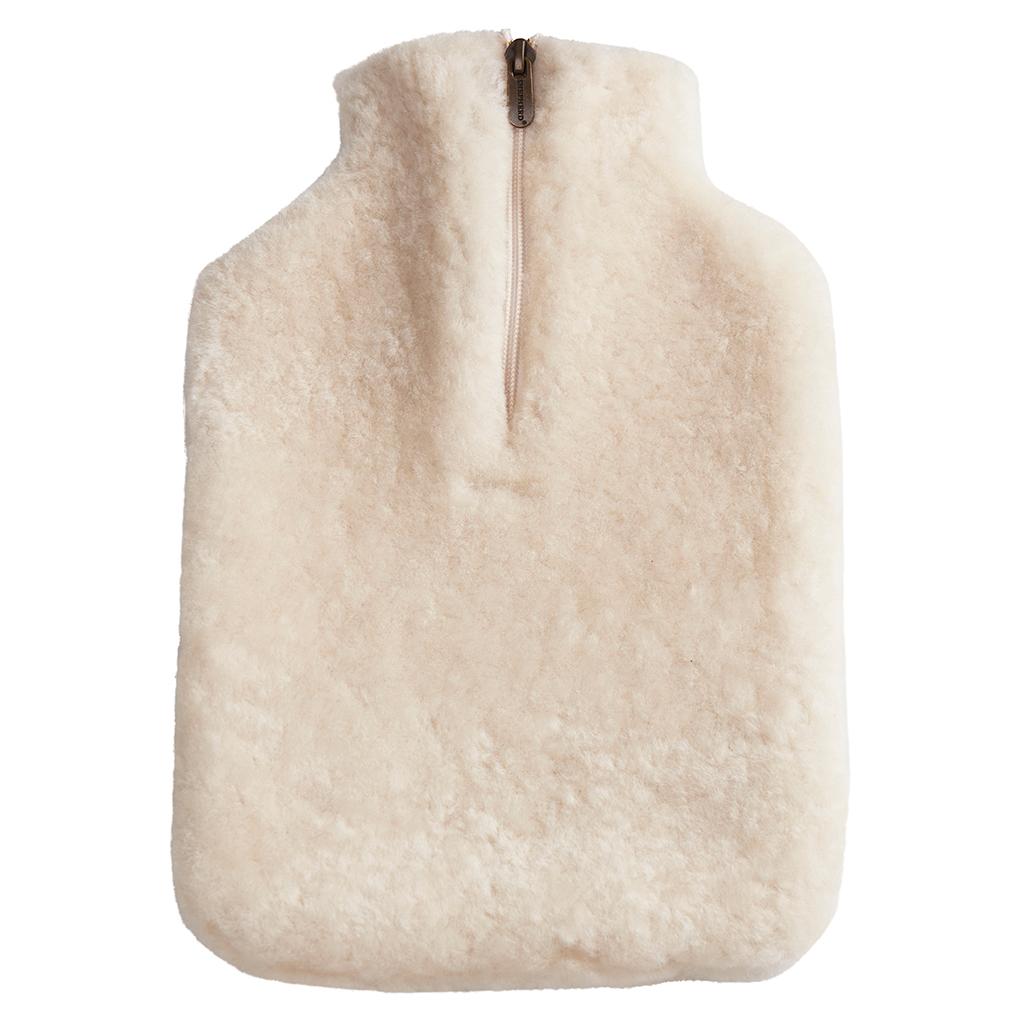 The Kerri Hot Water Bottle Cover in cream sheepskin by Shepherd of Sweden features a rectangular shape, soft fluffy texture, and visible zipper—ideal for muscle relief and soothing comfort.