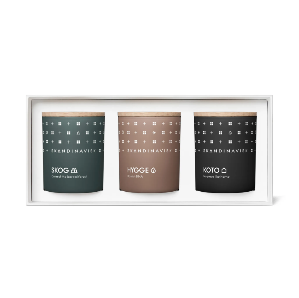 The Skandinavisk Scented Candle Hibernate Mini Giftset features SKOG, KOTO, and HYGGE candles made from Swedish rapeseed wax, each in a patterned glass and arranged in a sleek white box.