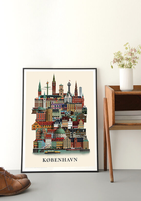 The Poster Copenhagen City A3 by Martin Schwartz, showcasing colorful iconic buildings and the city skyline, is framed and leans against a white wall beside a wooden table with a vase of flowers and brown shoes on the floor.