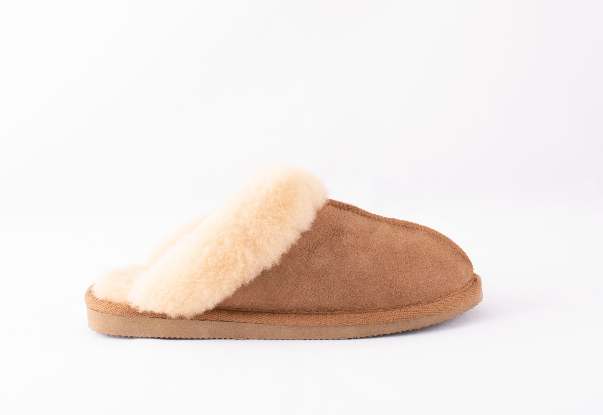 The Shepherd of Sweden Sheepskin Slippers - Jessica in Chestnut is a women's brown suede slipper with a soft cream lining, displayed from the side on a white background.