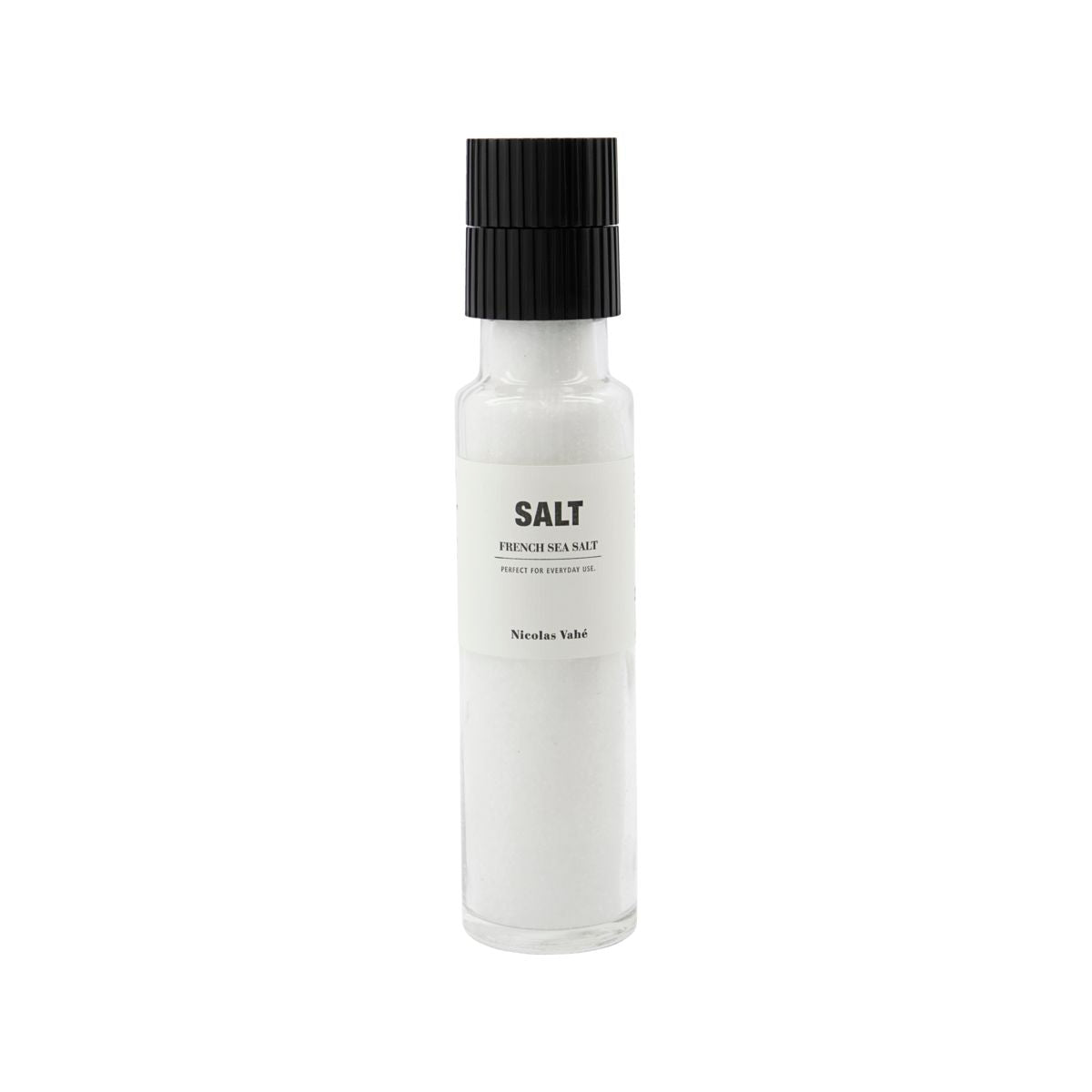 A clear glass grinder bottle of French Sea Salt from Nicolas Vahé, featuring a ceramic grinder top and a white label with Salt, French Sea Salt, Nicolas Vahé.