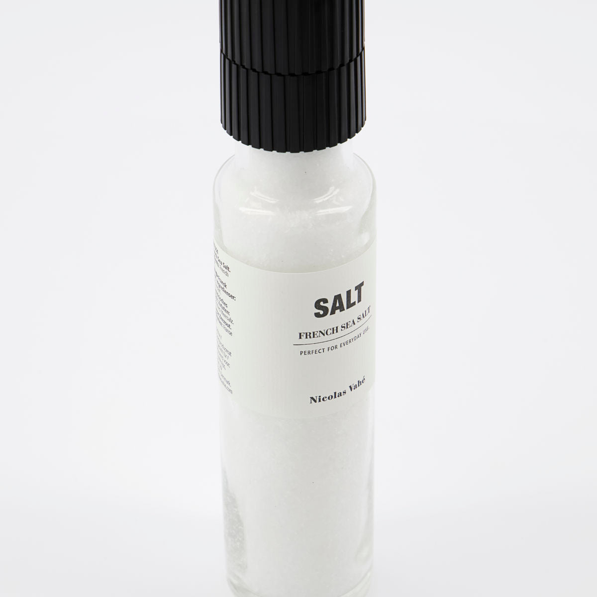 Nicolas Vahé French Sea Salt comes in a clear glass bottle with a black cap and ceramic grinder for easy seasoning. The label features the product name and details, letting you enjoy Mediterranean flavor with every twist.
