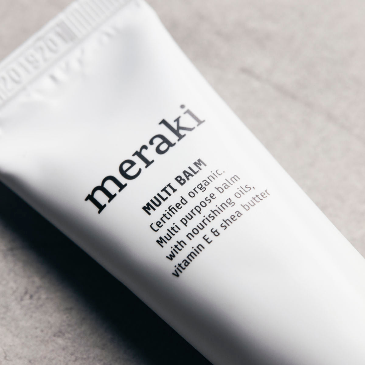 Close-up of Merakis Organic Multi Balm for Moisturising Dry & Damaged Skin 30 ml—a certified organic balm with nourishing oils, vitamin E, and shea butter—ideal for soothing and caring for dry skin.