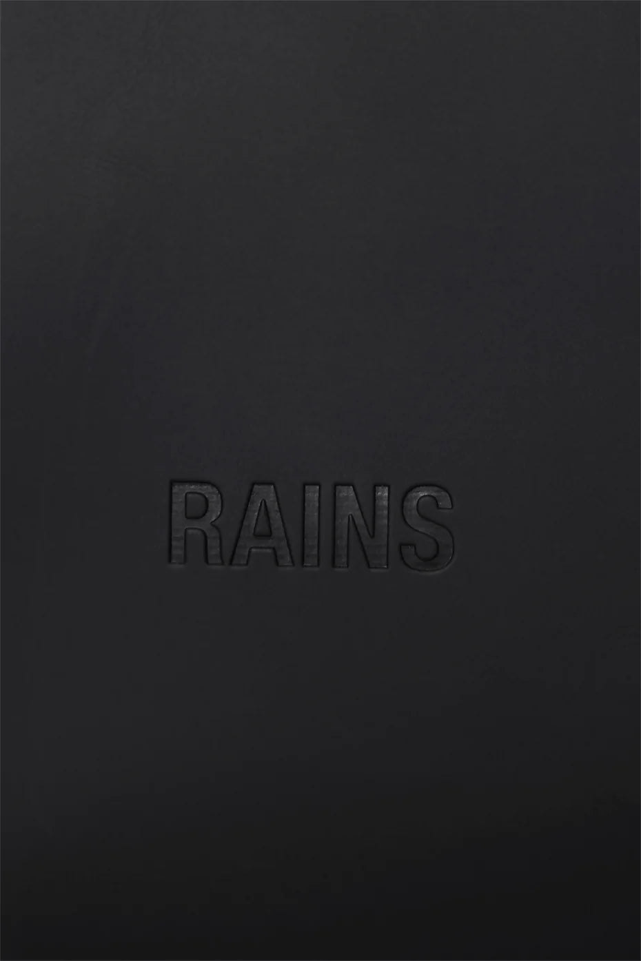 The Rains Bucket Backpack in Black features the brand’s name embossed at the center, crafted from Rains’ signature weatherproof PU fabric.