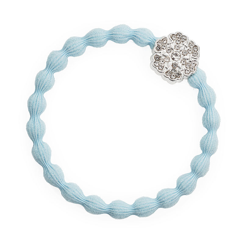 A light blue wavy elastic hair tie from ByEloise’s Bangle Band Ice Queen set of 2, featuring a silver snowflake charm decorated with small clear rhinestones.