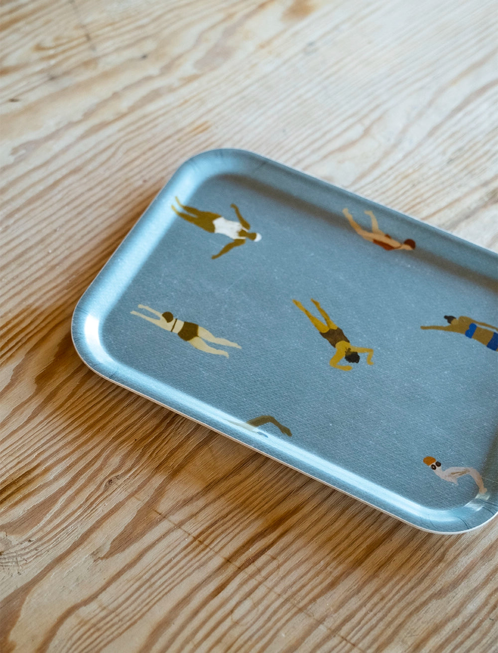 The Swimmers Tray by Fine Little Day is a 27 x 20 cm rectangular birch wood tray featuring swimmer illustrations, blending function with artistic flair. Designed by Elisabeth Dunker and FSC-marked, its perfect for stylish serving.