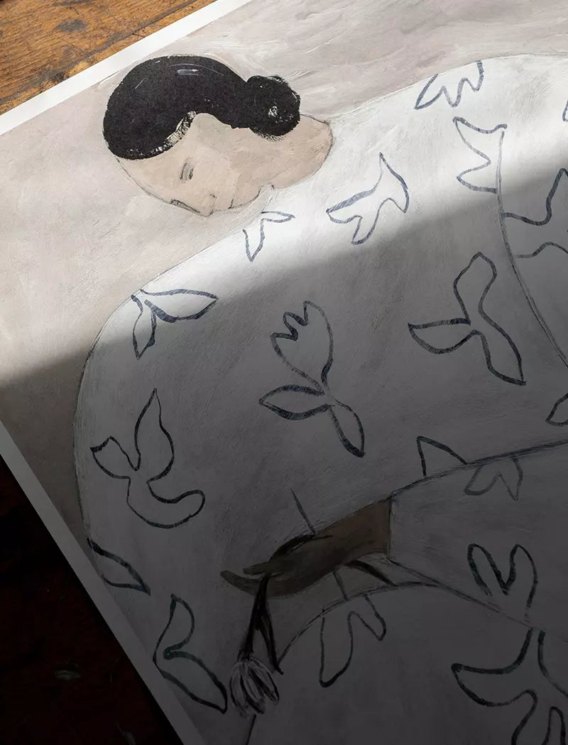 The White Flower Print 50x70 cm by Fine Little Day, created by Swedish designer Sofia Lind, features a dark-haired person in a white garment with abstract bird shapes, holding a wilted flower and partially shrouded in shadow.
