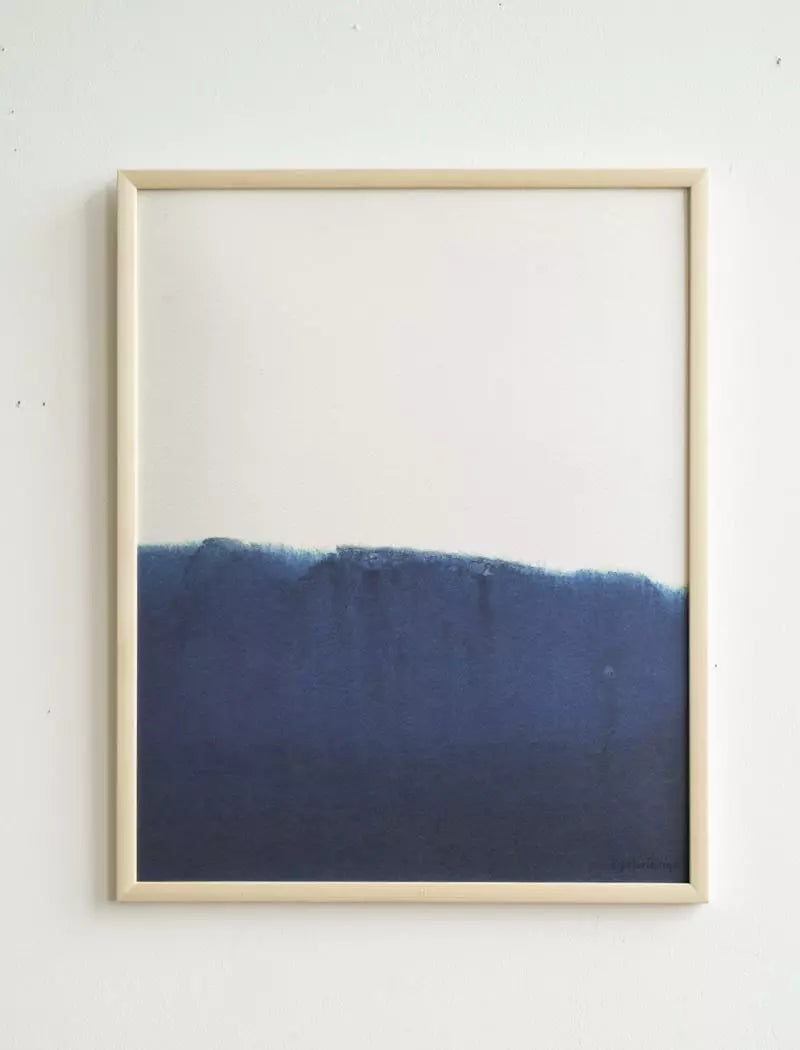 The Ocean 1 Print (40x50 cm) by Fine Little Day is a limited edition framed abstract artwork with a white upper half and deep blue lower half, divided by an uneven edge for a dip-dyed effect.