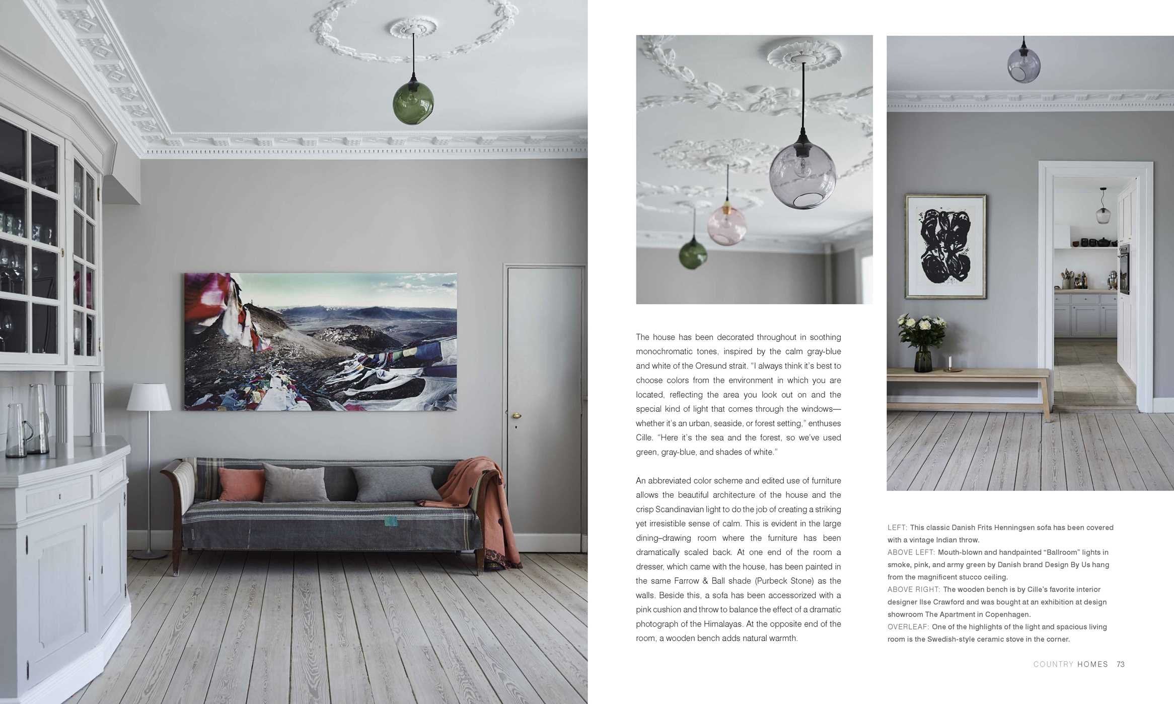 Inspired by The Scandinavian Home by Niki Brantmark, this living room features light wood floors, pale gray walls, and minimal neutral furnishings, all illuminated by glass pendants—capturing the essence of Scandinavian design.