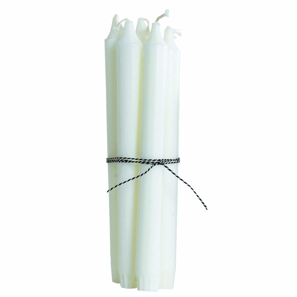 The White Classic Candles - Set of 4 by House Doctor, tied with a black and white string, make a stylish centrepiece on a crisp white background.