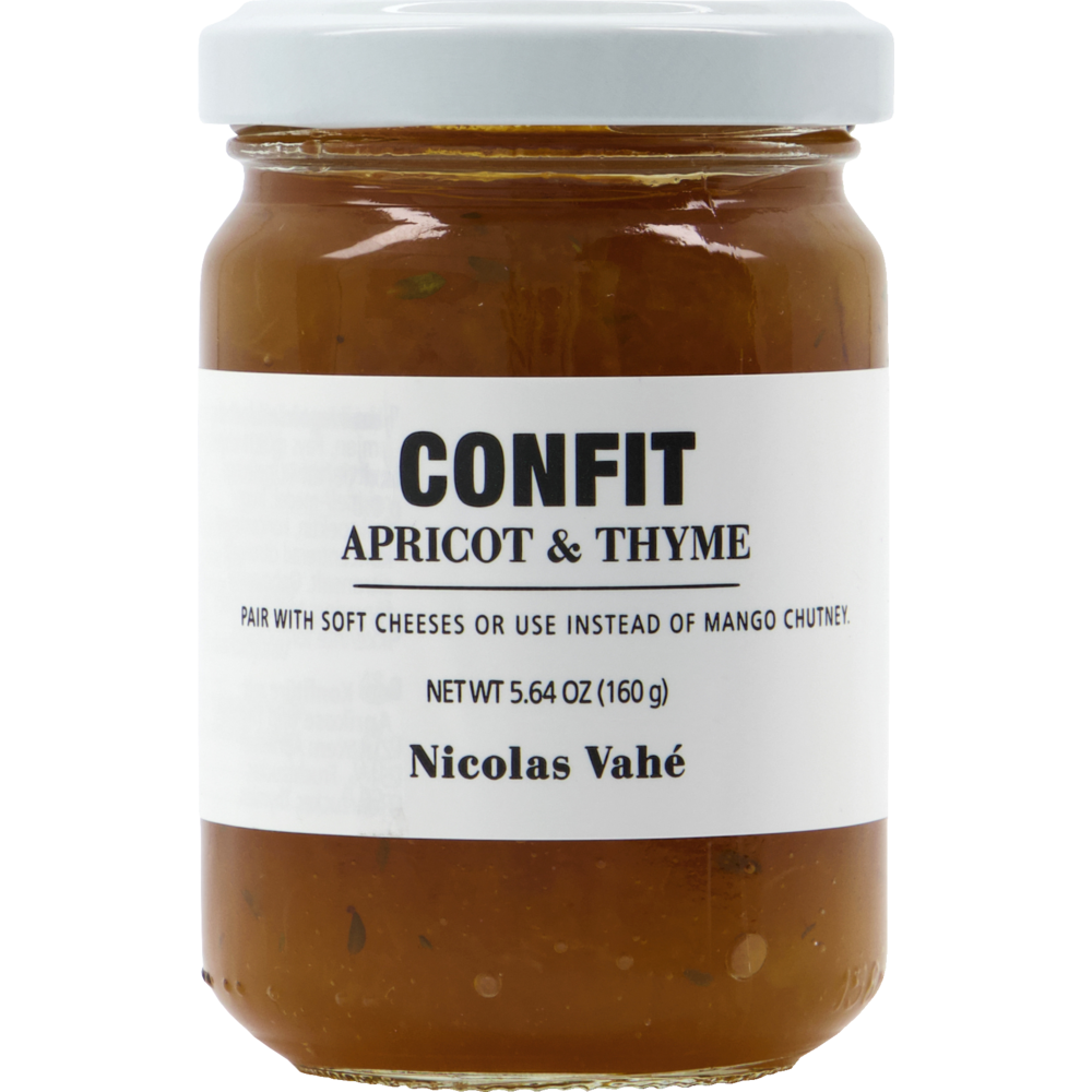 A glass jar of Confit, Apricot & Thyme by Nicolas Vahé. An orange preserve with herb pieces, it pairs well with soft cheeses or can be used as a mango chutney alternative, ideal for a cheese platter.
