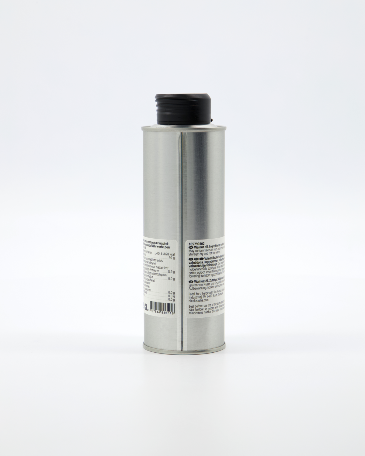 A tall, cylindrical metal container of Nicolas Vahé Walnut Oil with a black cap is shown from the back, displaying its label and barcode against a white background. This premium finishing oil is made in France.