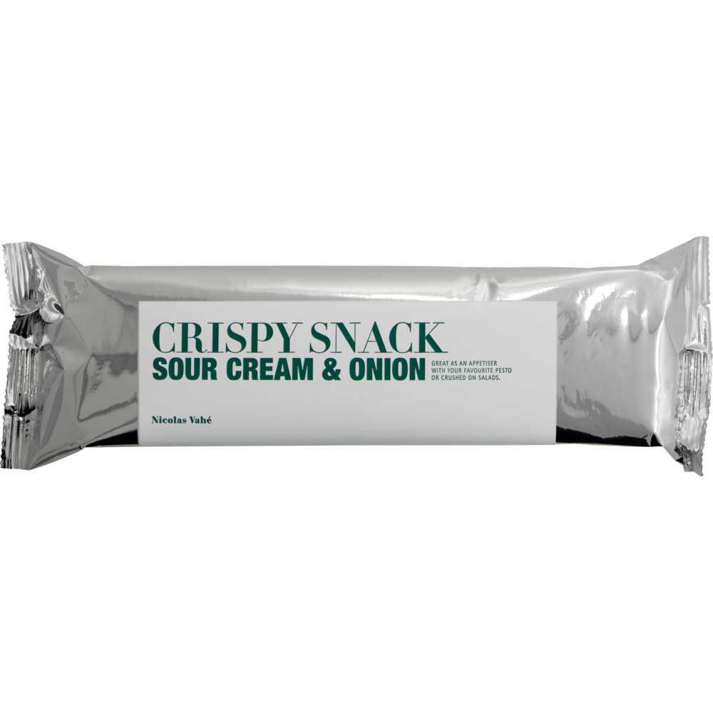 A silver-wrapped bar with a white label reading "Crispy Snack, Sour Cream & Onion" in green, and the Nicolas Vahé brand in small print at the bottom left—ideal for crispy potato snack lovers.