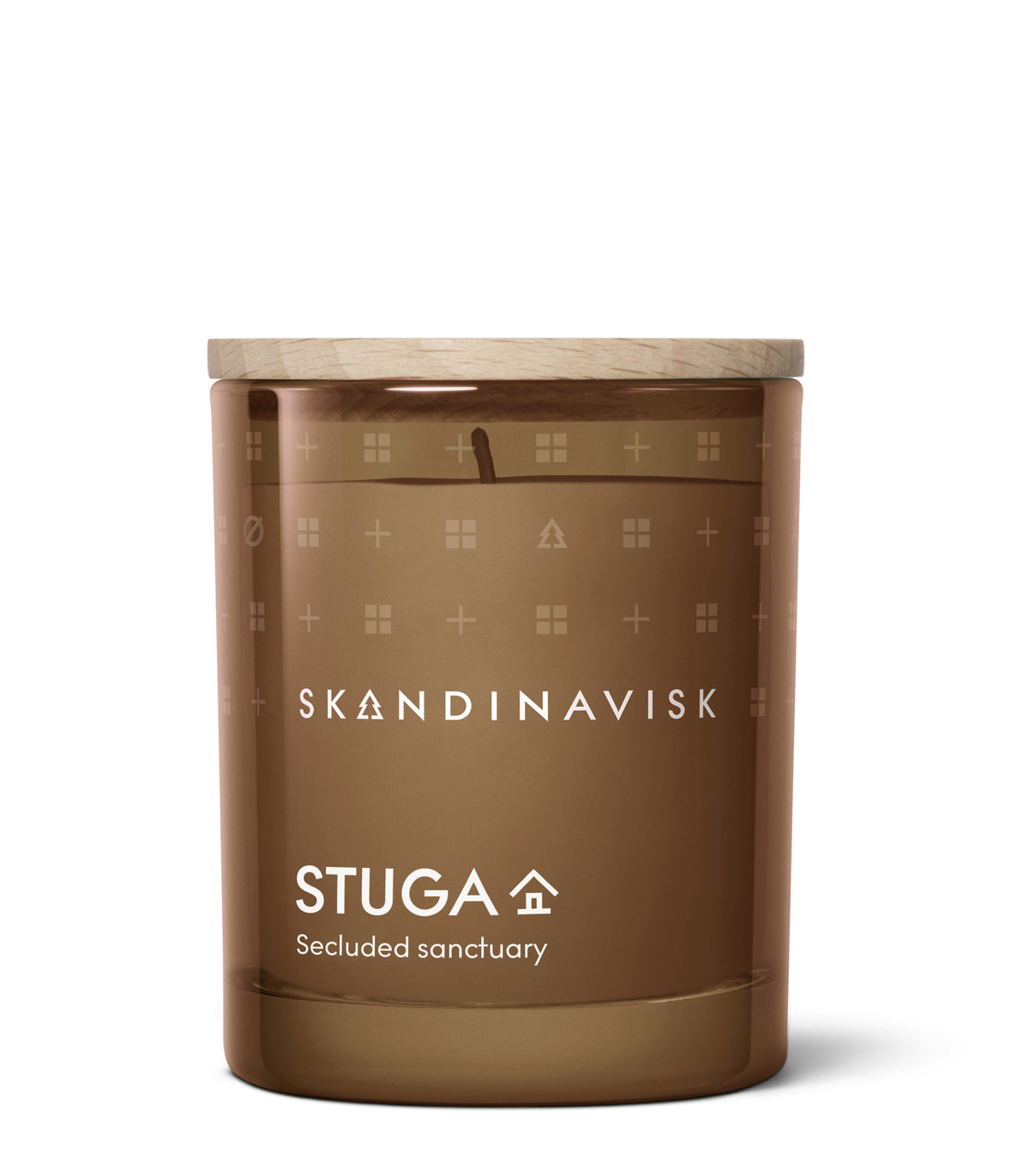 A 65 g Seasonal Scented Candle Stuga by Skandinavisk sits against a white background. The brown glass is adorned with simple icons and labeled “SKANDINAVISK” and “STUGA,” with “Secluded sanctuary” beneath. The candle features a wooden lid and is crafted from Swedish rapeseed wax, gently infused with the calming scent of birch bark—evoking the tranquil comforts of woodland mosses.