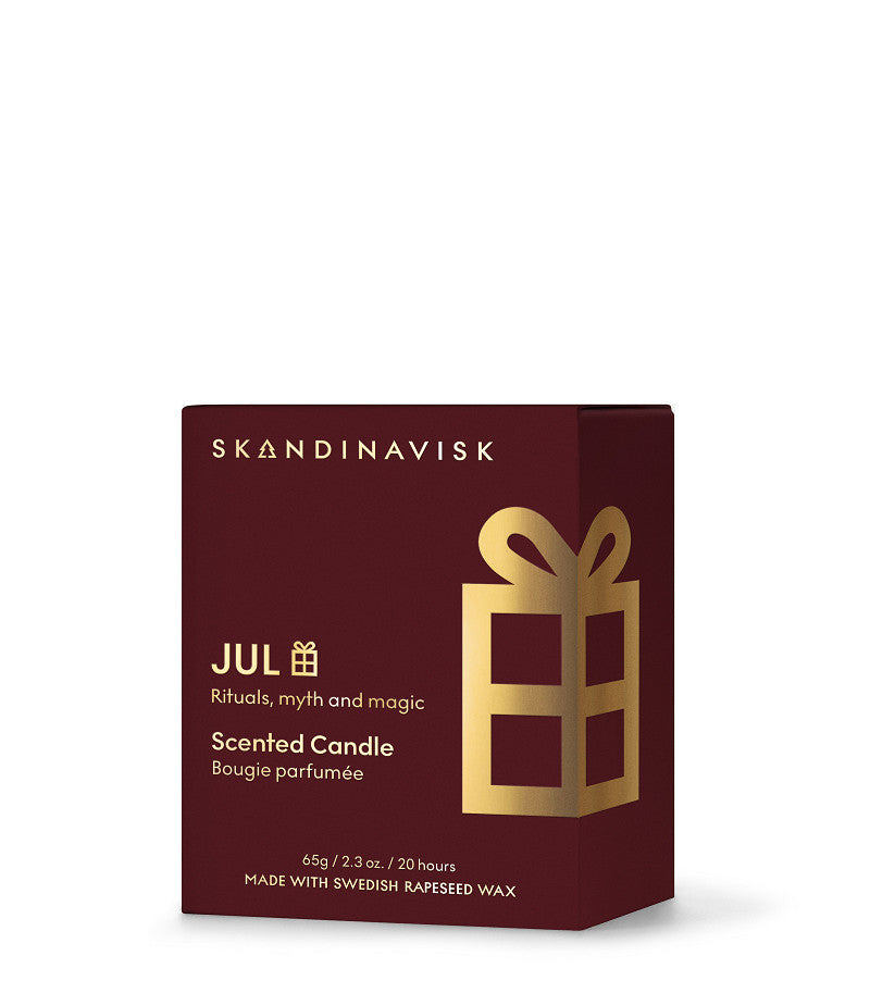 A maroon box labeled “Seasonal Scented Candle Jul Gold Symbol, 65 g” by Skandinavisk features a gold gift icon. This Scandinavian Christmas candle evokes rituals, myth, and magic, and is crafted with Swedish rapeseed wax for an authentic touch.