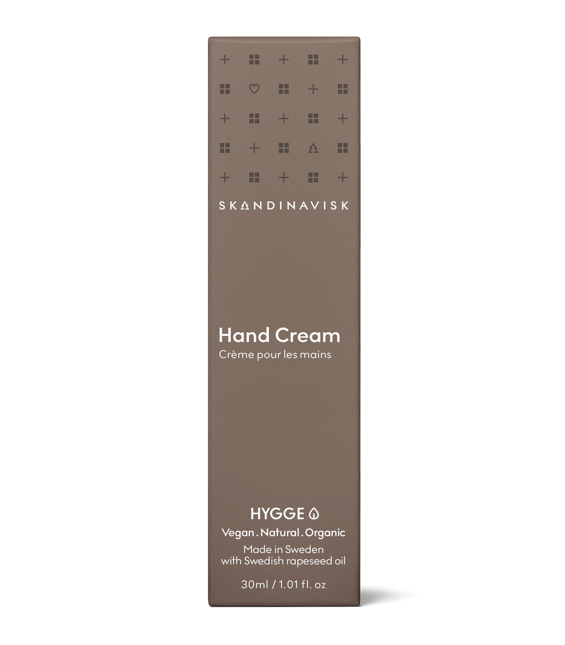 A brown rectangular box labeled "Mini Hand Cream Hygge, 30 ml" by Skandinavisk. The text highlights that it is vegan, natural, organic, and made in Sweden with Swedish rapeseed oil and organic aloe vera. This Scandinavian skincare vegan moisturizer comes in a 30 ml (1.01 fl. oz.) box.