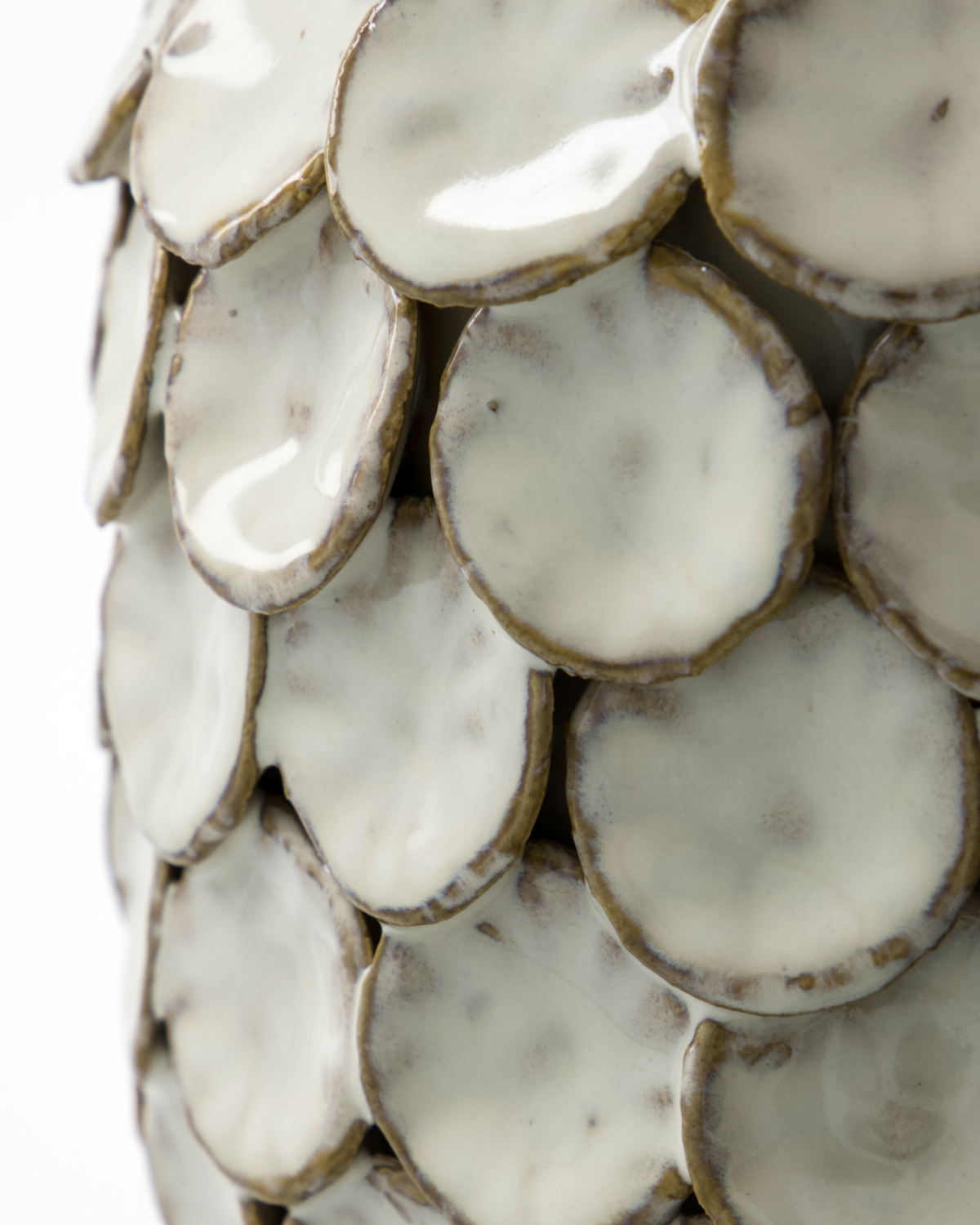 Close-up of the Dot Ceramic Vase, 15 cm by House Doctor, featuring overlapping round ceramic tiles with a glossy off-white glaze and brownish edges for a sculptural, scale-like texture.