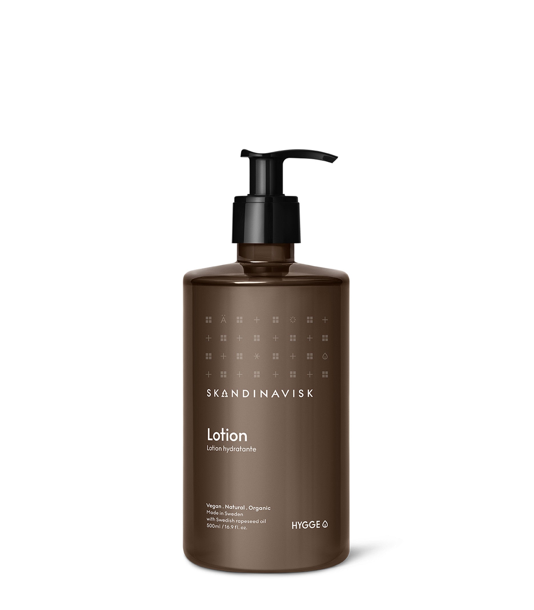 A brown pump bottle labeled Skandinavisk Hand & Body Lotion Hygge, featuring minimalist white text and icons on the front, highlights its credentials as a vegan, natural, and organic hand and body lotion. Infused with organic aloe vera, this 500 ml Scandinavian skincare essential offers gentle nourishment for your skin.