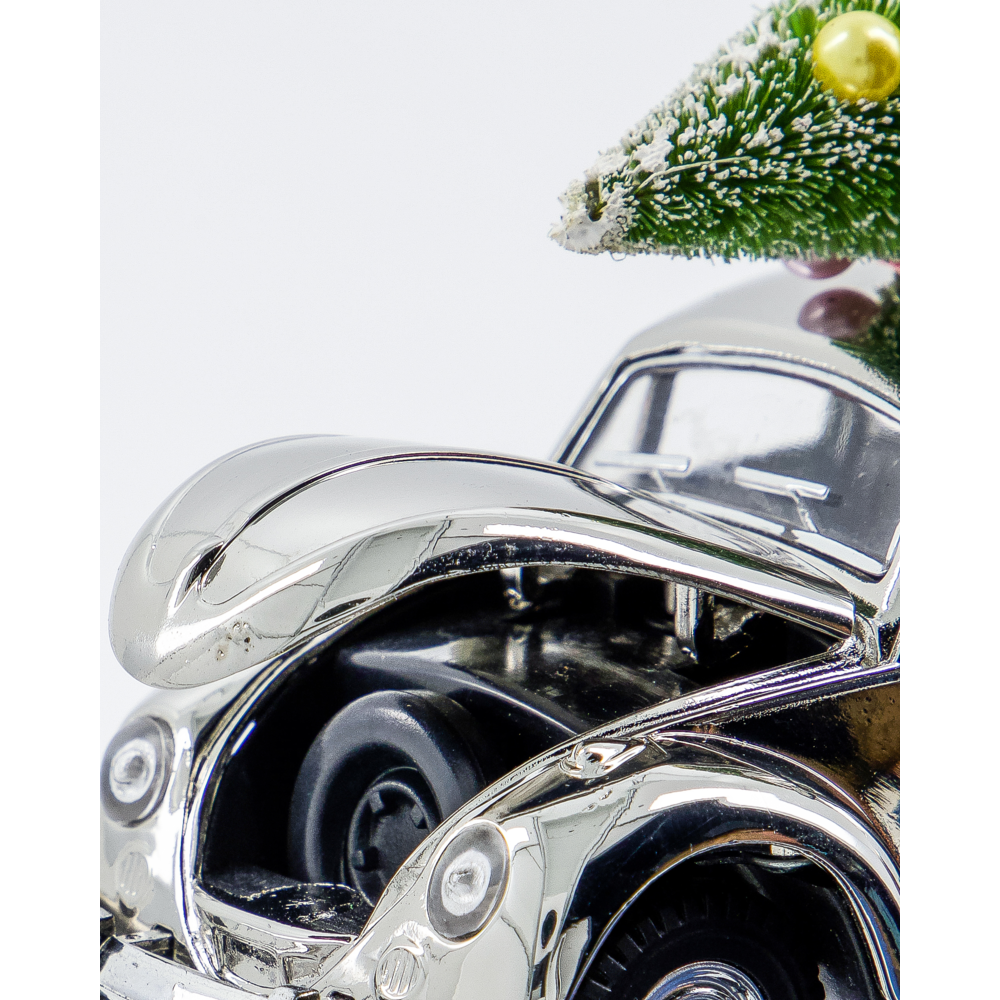 A silver House Doctor Ornament Xmas Car Christmas Decoration featuring a car with an open hood and a miniature Christmas tree on its roof.