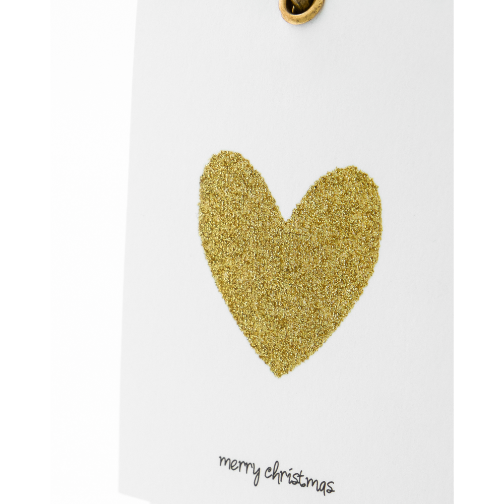 Holiday Gift Tags in Gold featuring a white tag with a gold glitter heart and the handwritten text merry christmas.