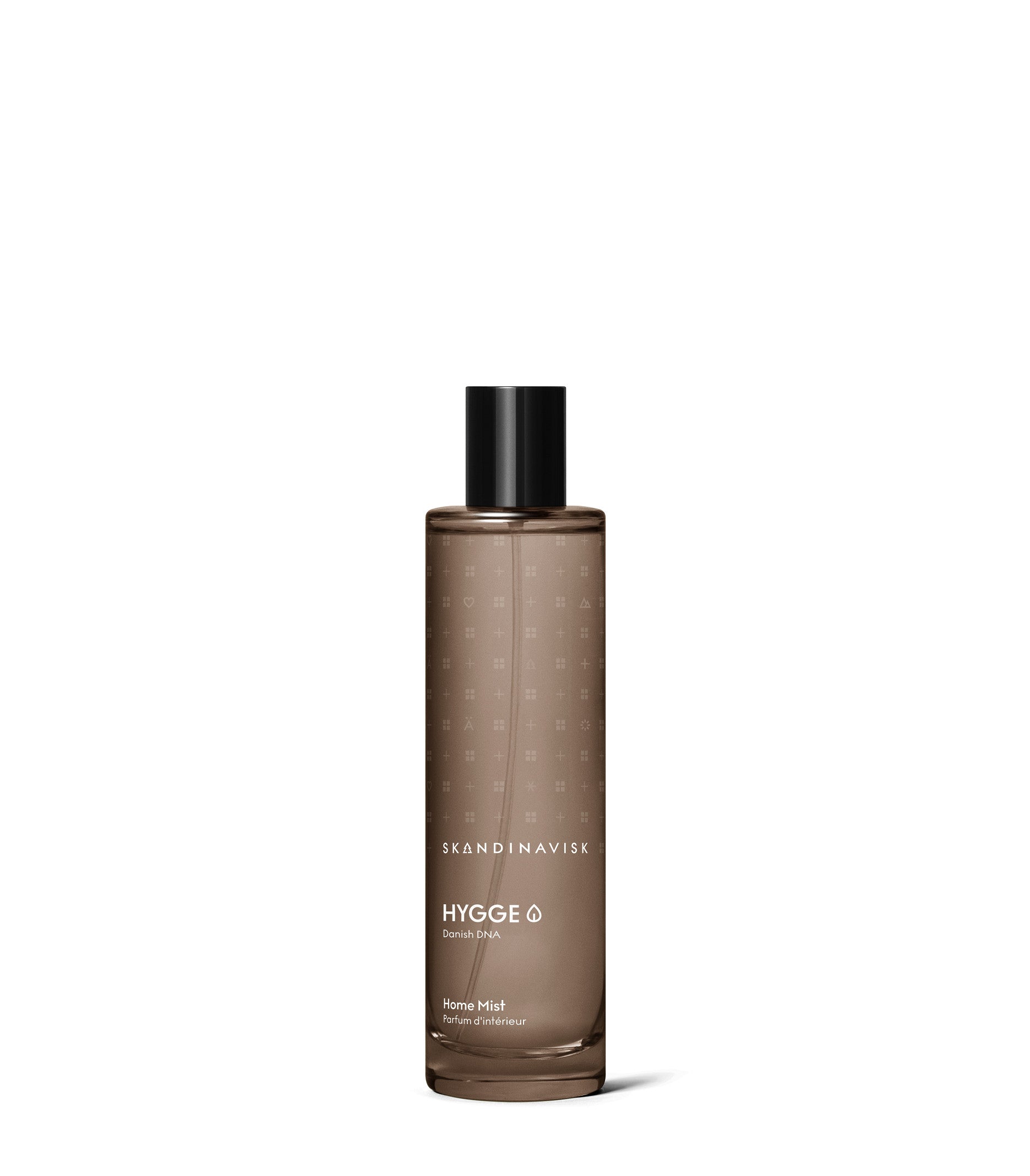 A soothing home fragrance in a brown translucent bottle labeled “Skandinavisk Home Mist Hygge, 100 ml” with a black cap, set against a white background—invoking the warmth of Scandinavian hygge.