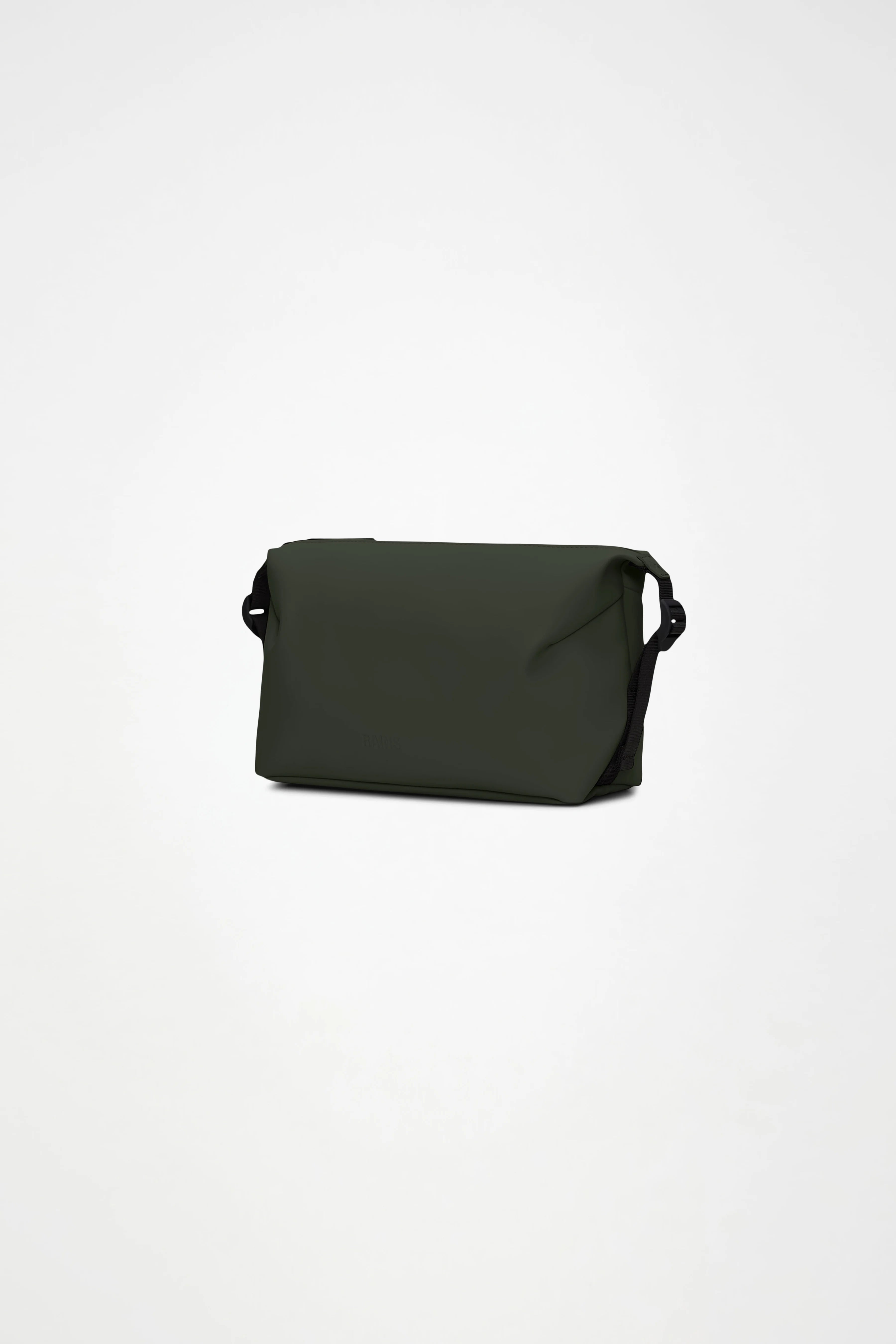 The Rains Hilo Wash Bag W3 in Green by Rains is a dark green rectangular bag with a flap closure and black side details, designed to double as a travel wash bag, shown against a plain white background.