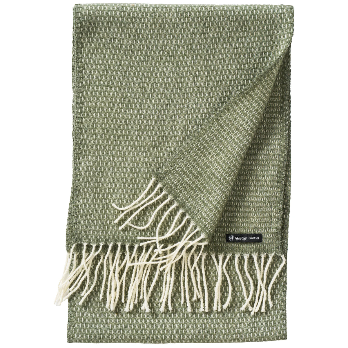 A neatly folded Hugo Scarf in Dusty Green from Klippan Yllefabrik, crafted from recycled and new merino wool, features white accents and delicate fringe at the ends, with one corner turned up to showcase its elegant woven texture.