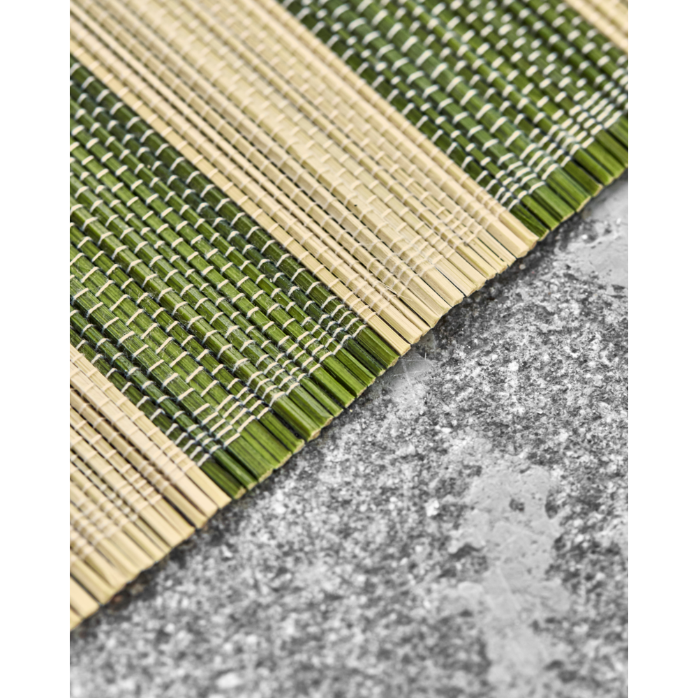 A close-up of House Doctor’s Rayas Placemats, Green & Nature Stripe (Set of 4), displayed on a textured gray stone surface.