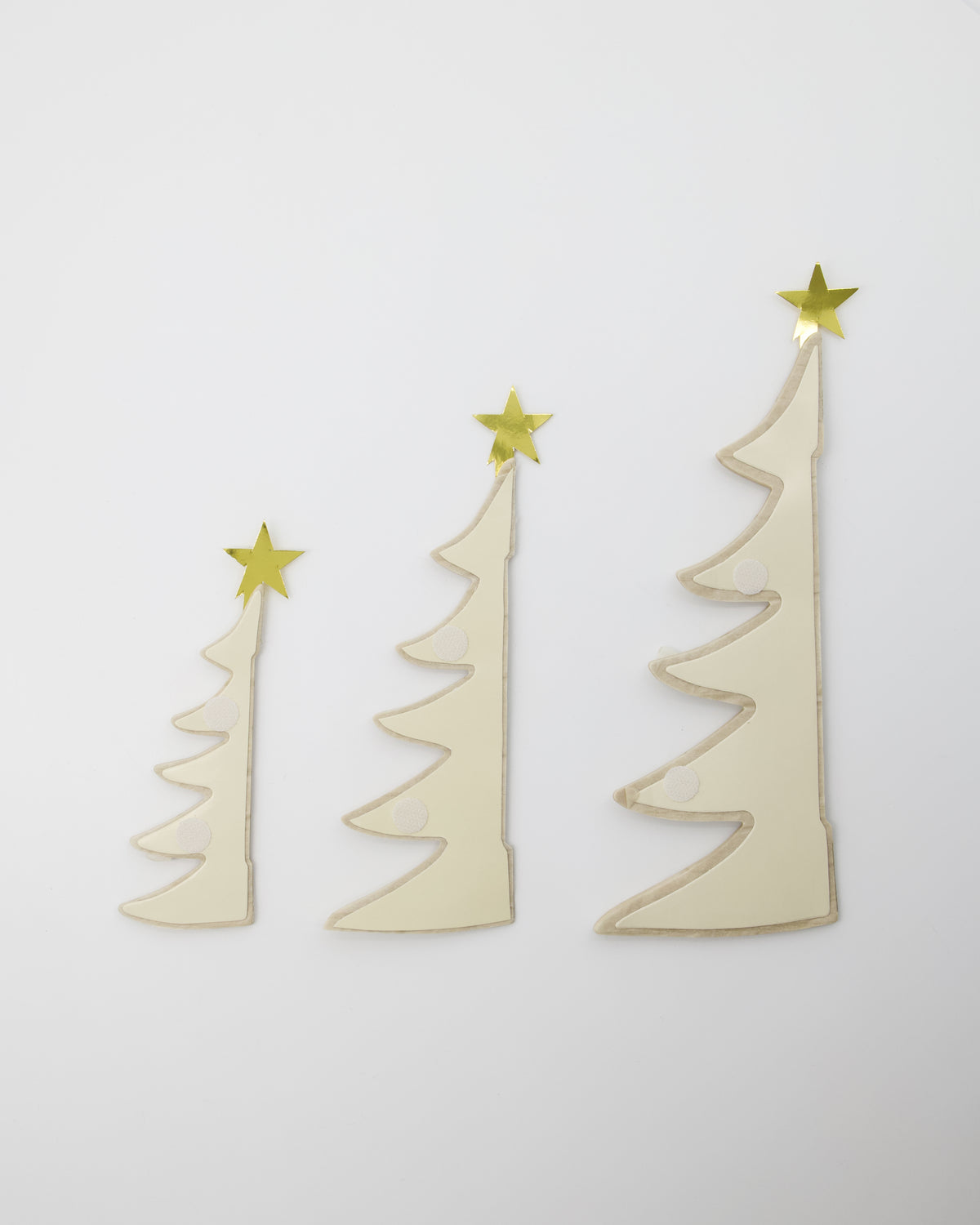 House Doctor Christmas Tree Ornament, Set of 3 in Paper, Ivory & Gold feature three ivory-colored paper trees of varying heights, each topped with a gold foil star.