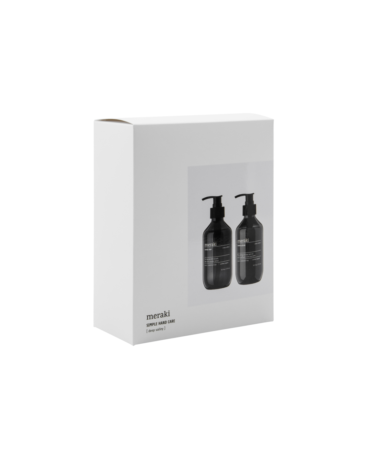 A white rectangular gift box with a clear window displays two black pump bottles inside. Labeled Meraki Gift Box Deep Valley, this modern set includes hand soap & hand lotion—an ideal hand care gift.