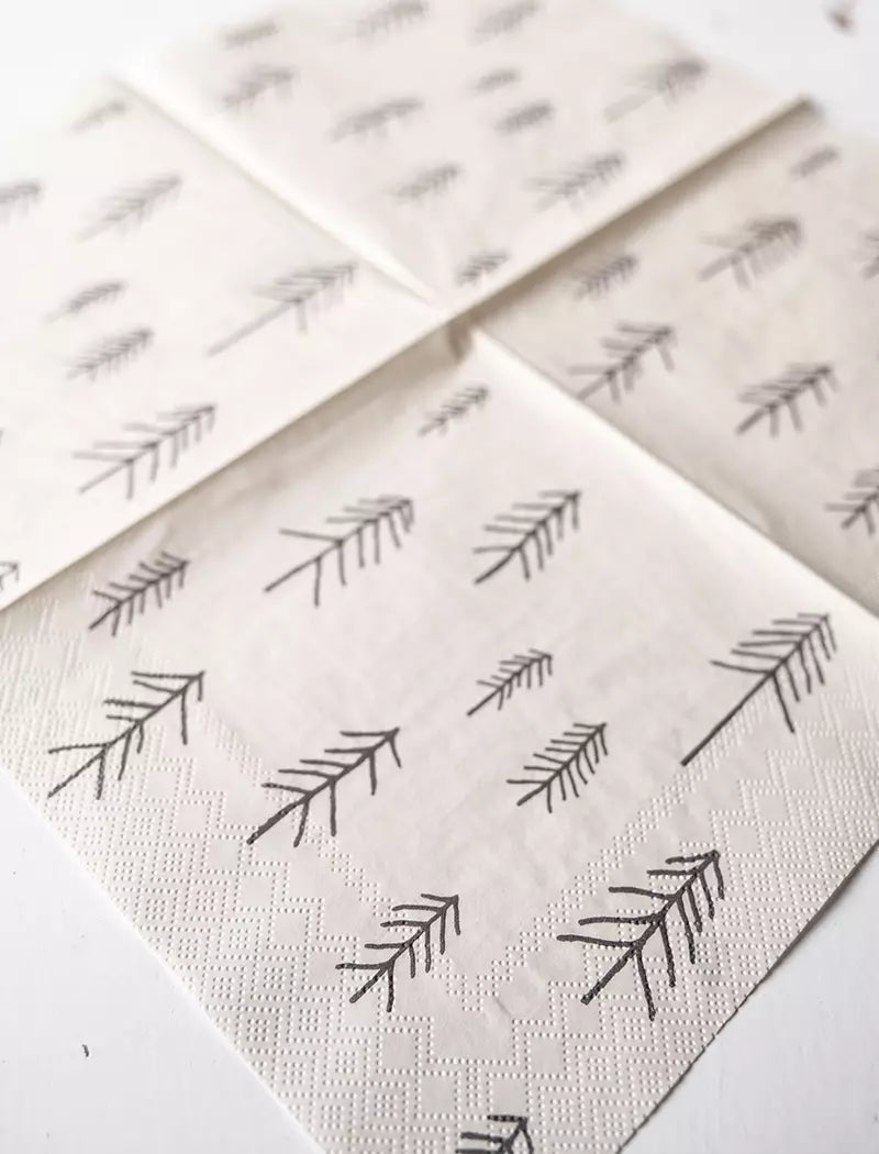 Four Pine (Tall) Paper Napkins by Fine Little Day, sized 33x33 cm, feature a simple black branch design on white—ideal for minimalist table settings when arranged in a neat, overlapping square.