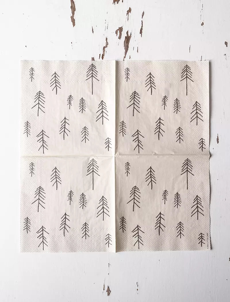 The Pine (Tall) Paper Napkins by Fine Little Day (33 cm x 33 cm) feature a black minimalist pine tree print on white, ideal for Scandinavian décor and modern table settings.
