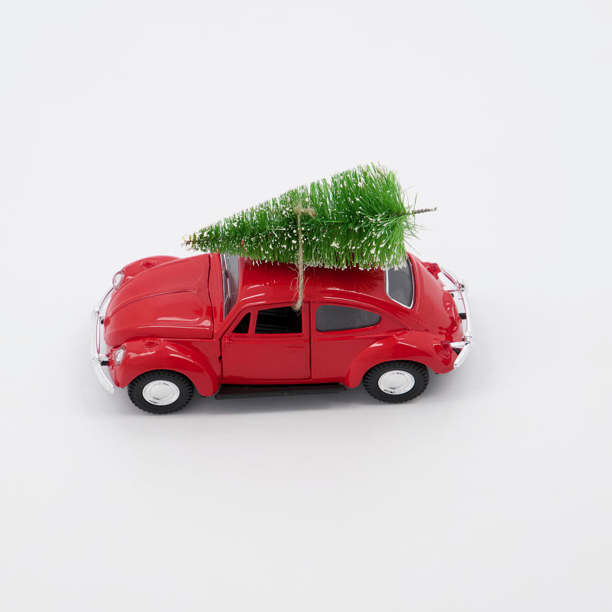 The House Doctor Ornament Xmas Car Christmas Decoration in Red features a small red car with a green tree on its roof, ideal as a festive ornament or nostalgic décor, set against a plain white background.