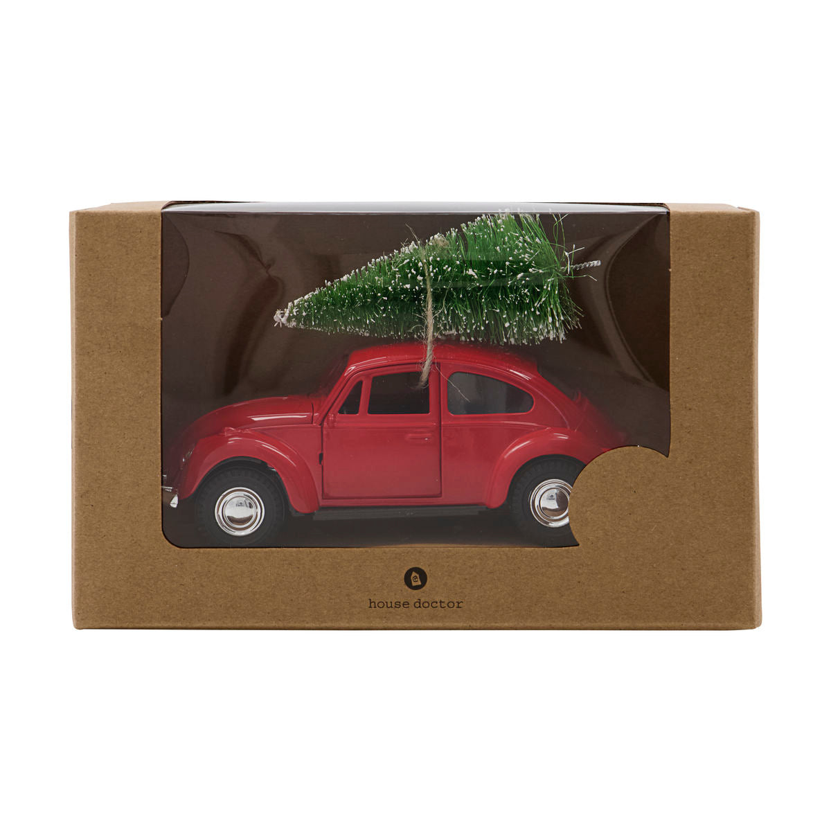 The Ornament Xmas Car Christmas Decoration in Red by House Doctor features a festive red car with a green tree on its roof, packaged in a windowed box—ideal as a nostalgic holiday décor or Christmas ornament.