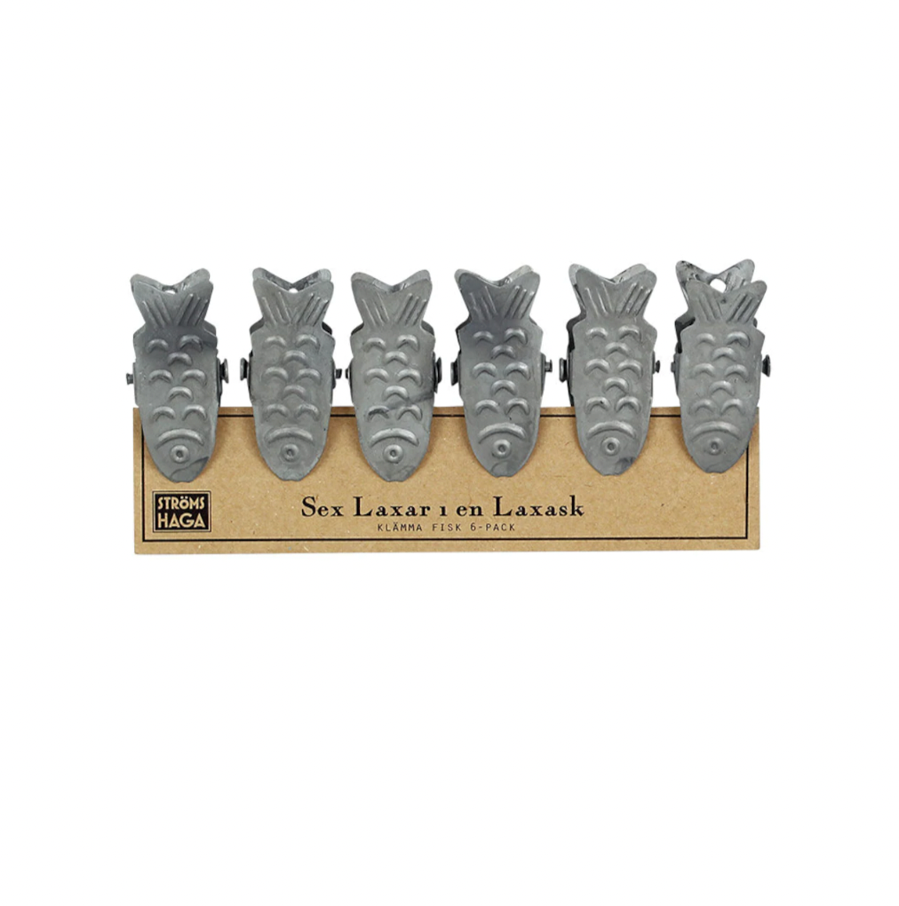 Six metal Clip Fish from Strömshaga come in a 6-pack on cardboard backing labeled “Sex Laxar i en Laxask.” Ideal as card holders or quirky kitchen towel holders.