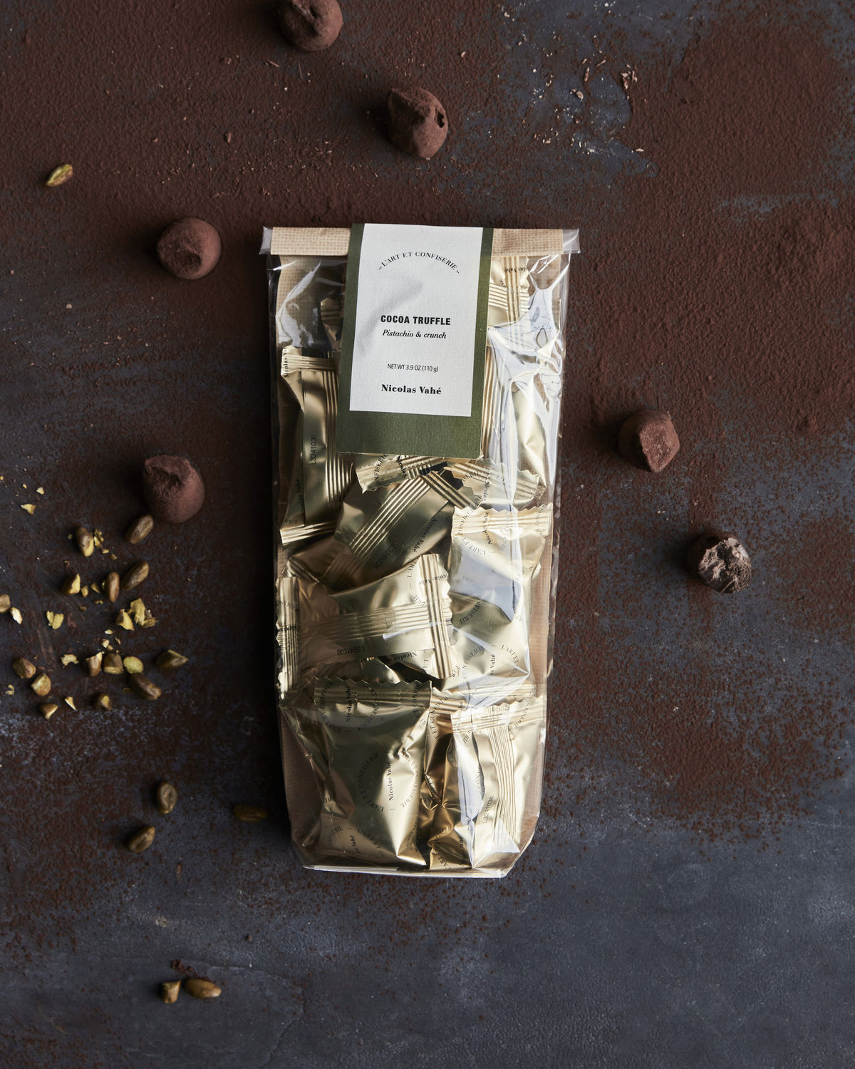 A bag of Nicolas Vahé’s Chocolate Truffles, Pistachio & Crunch sits temptingly on the table, ready to enjoy.