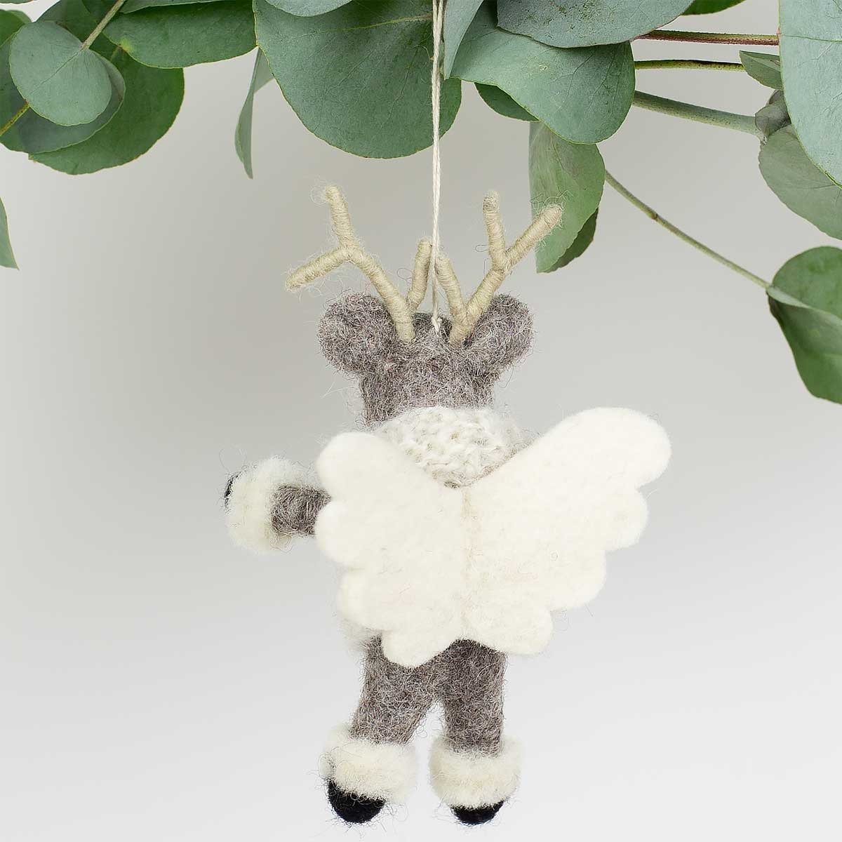 A World of Craft’s 14cm wool Elk Angel Christmas ornament, featuring antlers and white wings, brings a whimsical touch to your festive decor as it hangs from a leafy branch.