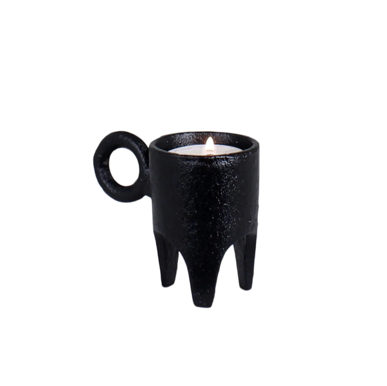 The Strömshaga Tea Light Holder Three Feet in Cast Iron (8cm) is a small black holder with three legs and a circular handle, shown here holding a lit tealight candle.
