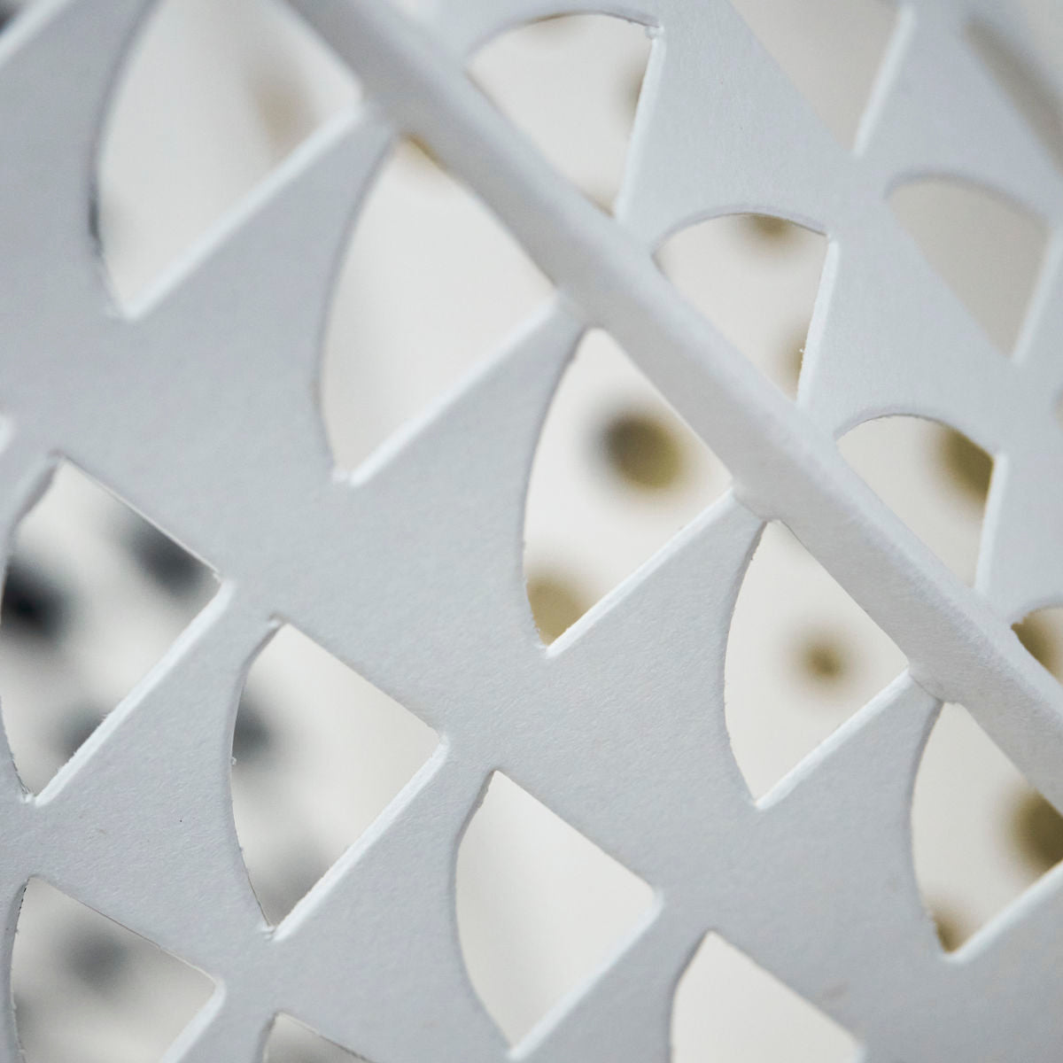 Close-up of the Gint Paper Star, 45 cm by House Doctor—a white geometric ornament with diamond and semicircle cutouts, perfect as a large Christmas decoration.