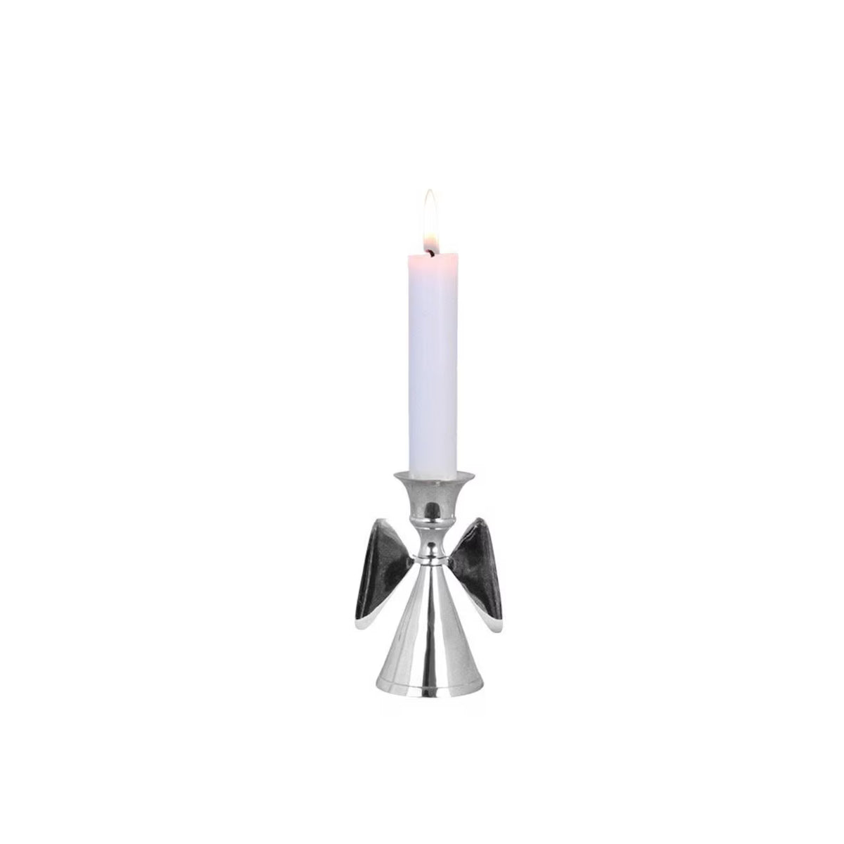 A lit white candle stands in the Strömshaga Candle Holder Angel in Nickel, featuring beautifully flared wings and a cone-shaped base, set against a plain white background—an elegant piece ideal as a baptism gift or Christmas present.