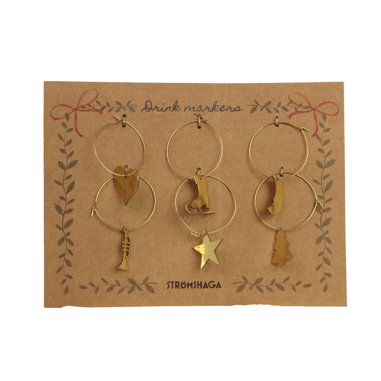 Strömshaga’s Wine Glass Charms set includes six brass Christmas-themed markers—heart, ice skate, bell, trumpet, star, and tree—displayed on a “Drink markers” card.