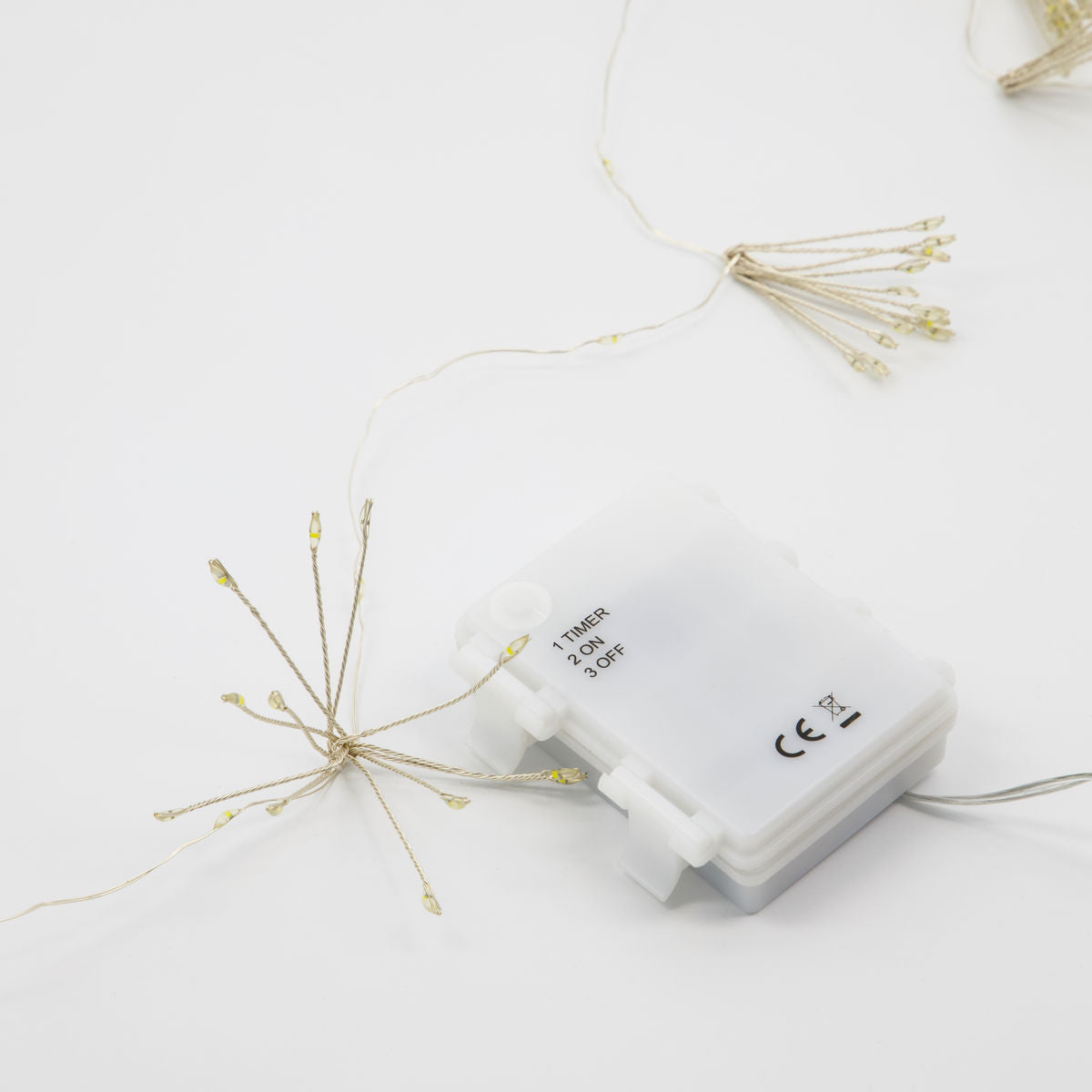 The House Doctor Glow LED String Lights, Silver Finish 1.5m, feature a white battery pack with timer switch and delicate starburst-shaped LEDs, displayed on a plain white background.