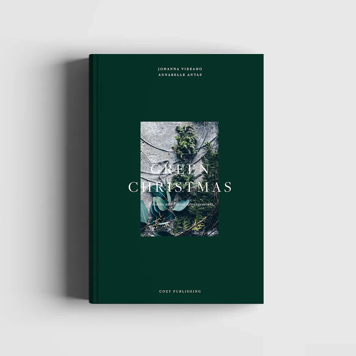 A book cover for 'Green Christmas - Wreaths & Floral Arrangements' featuring a close-up photograph of a Christmas wreath on a dark green background.