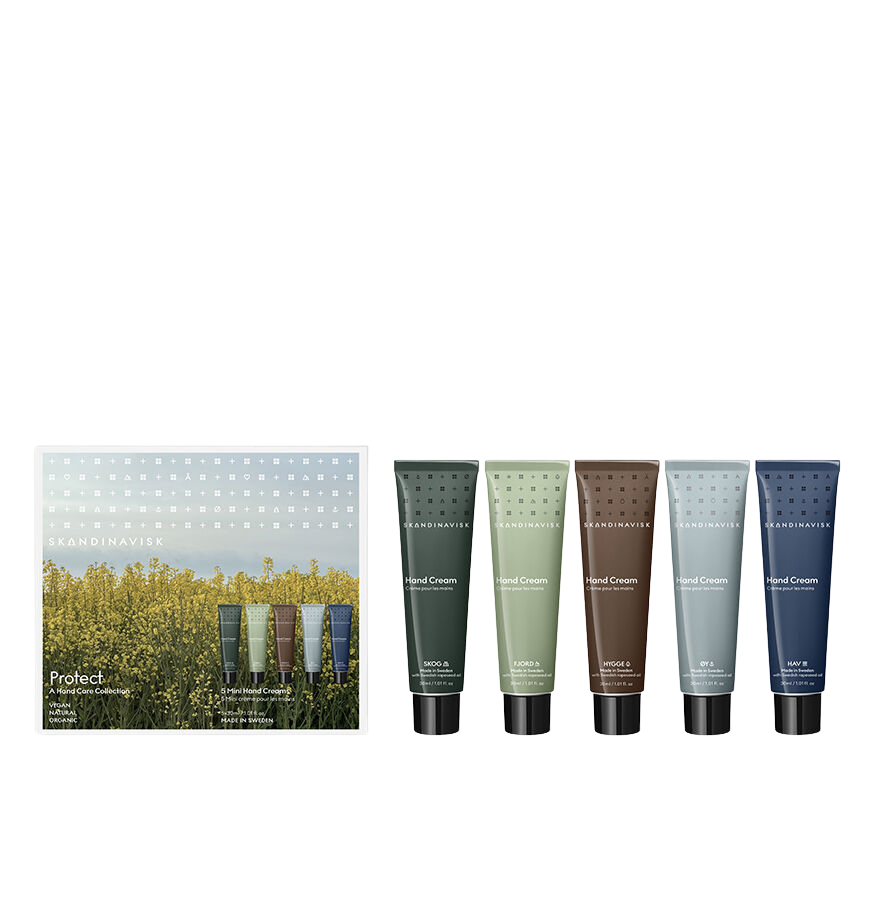 A Skandinavisk Giftset Mini Hand Cream Protect, featuring five hand cream tubes in SKOG, FJORD, ØY, HAV, and HYGGE scents—each made with natural ingredients and organic aloe vera—is displayed in an array of colors in front of a box adorned with a yellow floral landscape design.