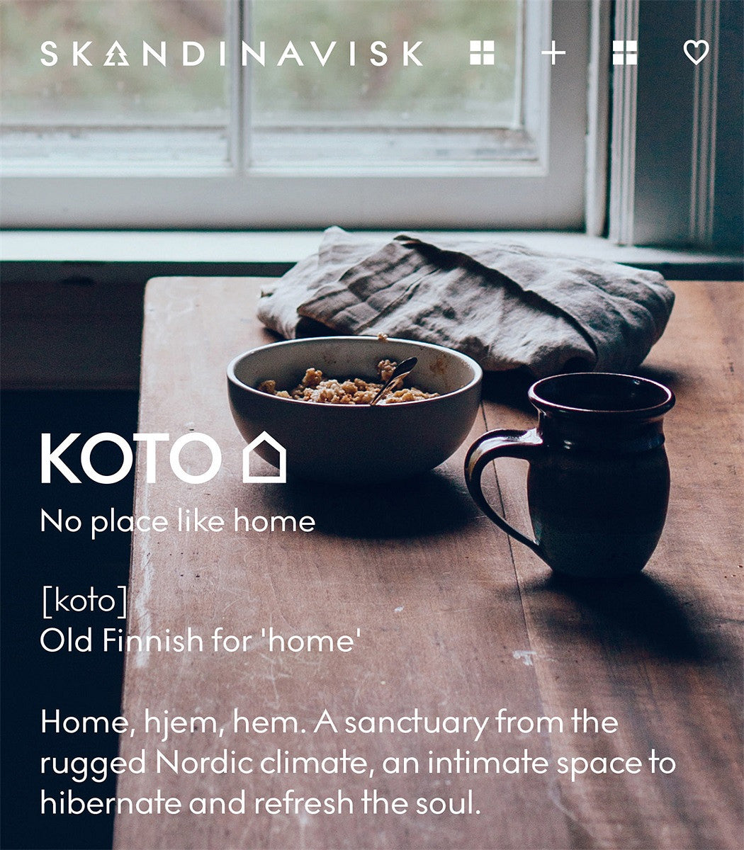 On a wooden table by a window, a bowl and mug rest alongside Skandinavisk’s Giftset Scented Candles Hibernate with 3 Mini Candles—Skog, Koto & Hygge—each crafted from Swedish rapeseed wax. The gentle flicker of these candles fills the space with comforting fragrance, while text on the scene explains that “koto,” the Finnish word for home, describes a cozy sanctuary. This inviting giftset is perfect for anyone seeking comfort and warmth.