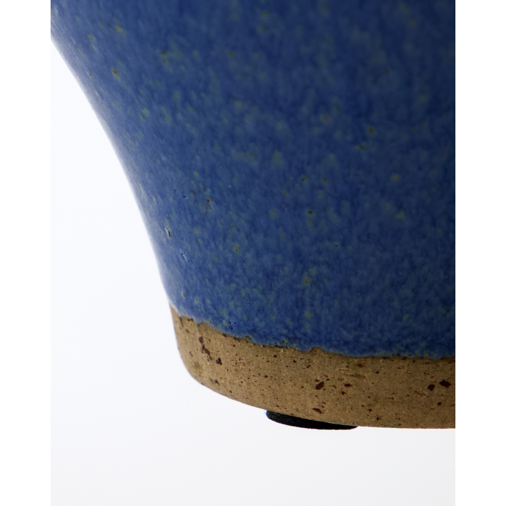 Close-up of the bottom of the House Doctor Vase, Kolo, Blue (Set of 2) showing its textured glaze and unglazed speckled brown base against a plain white background.
