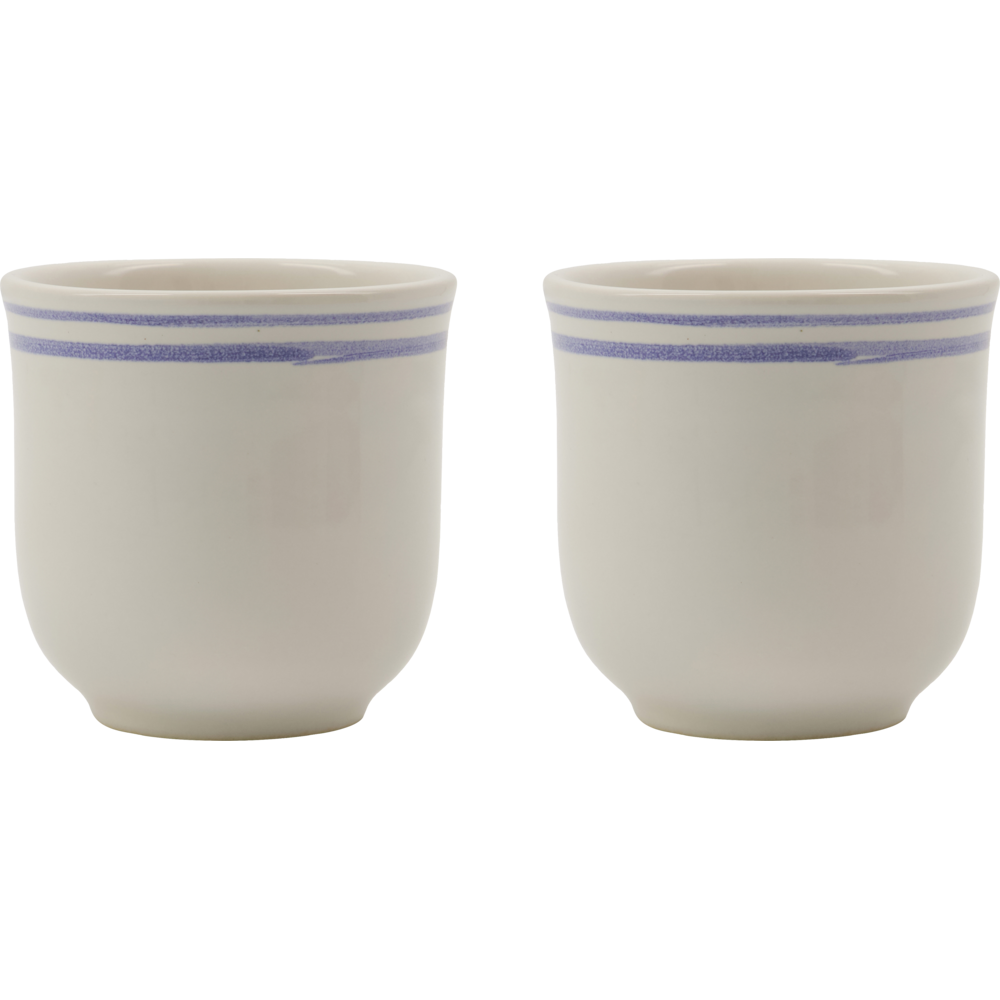 The Nicolas Vahé Mug Bistro Blue Line set includes two white stoneware mugs, each with simple design and two thin blue stripes near the rim, shown side by side on a plain light background.