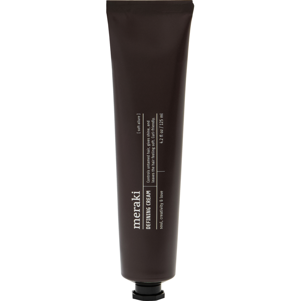 A dark brown tube of Meraki Defining Cream, Soft Allure is shown upright with white text and a black cap on a plain white background, making it a stylish companion alongside your favorite curl-friendly hair care or nourishing hair cream.