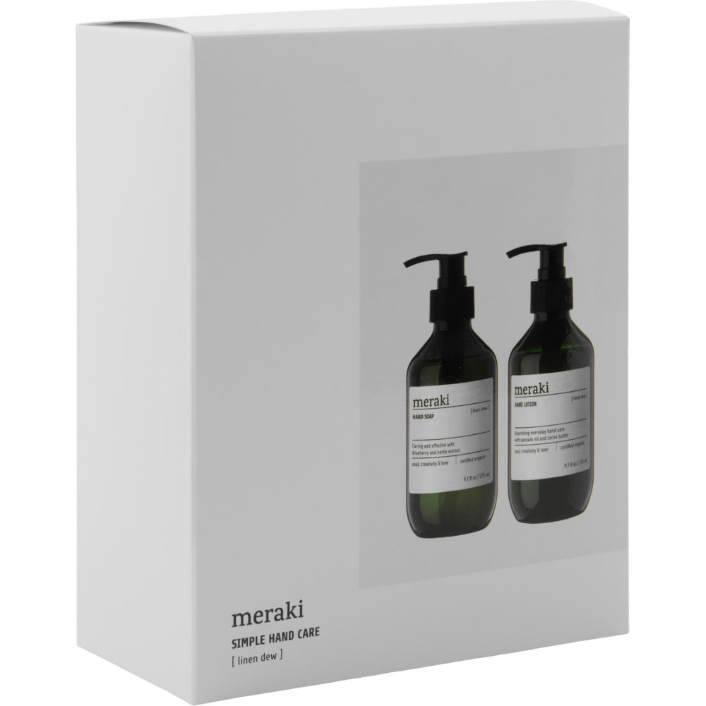 A white box featuring the Meraki logo and an image of two green pump bottles contains the "Giftbox Linen Dew Organic, Hand Soap & Hand Lotion." The box text reads: meraki SIMPLE HAND CARE [linen dew]. This gift set from Meraki includes both Organic Hand Soap and Hand Lotion in the refreshing Linen Dew scent.