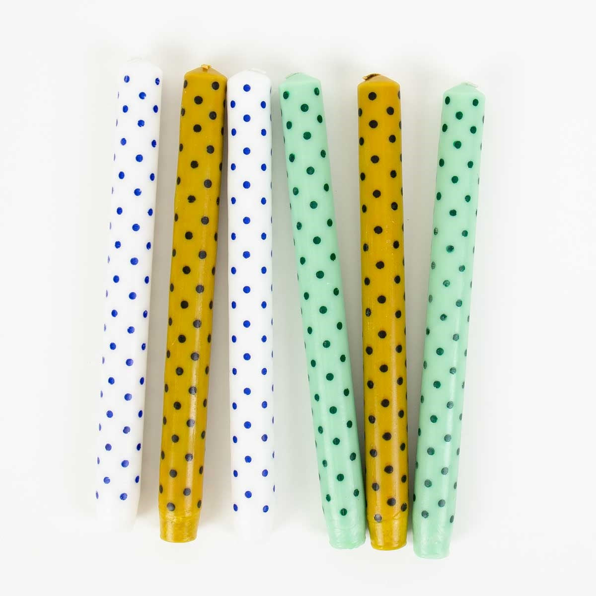 Six Candles Minidot Mustard and Black, Handmade 2 Pack taper candles arranged vertically, featuring white, yellow, and light green wax with blue, black, and dark green polka dot patterns.